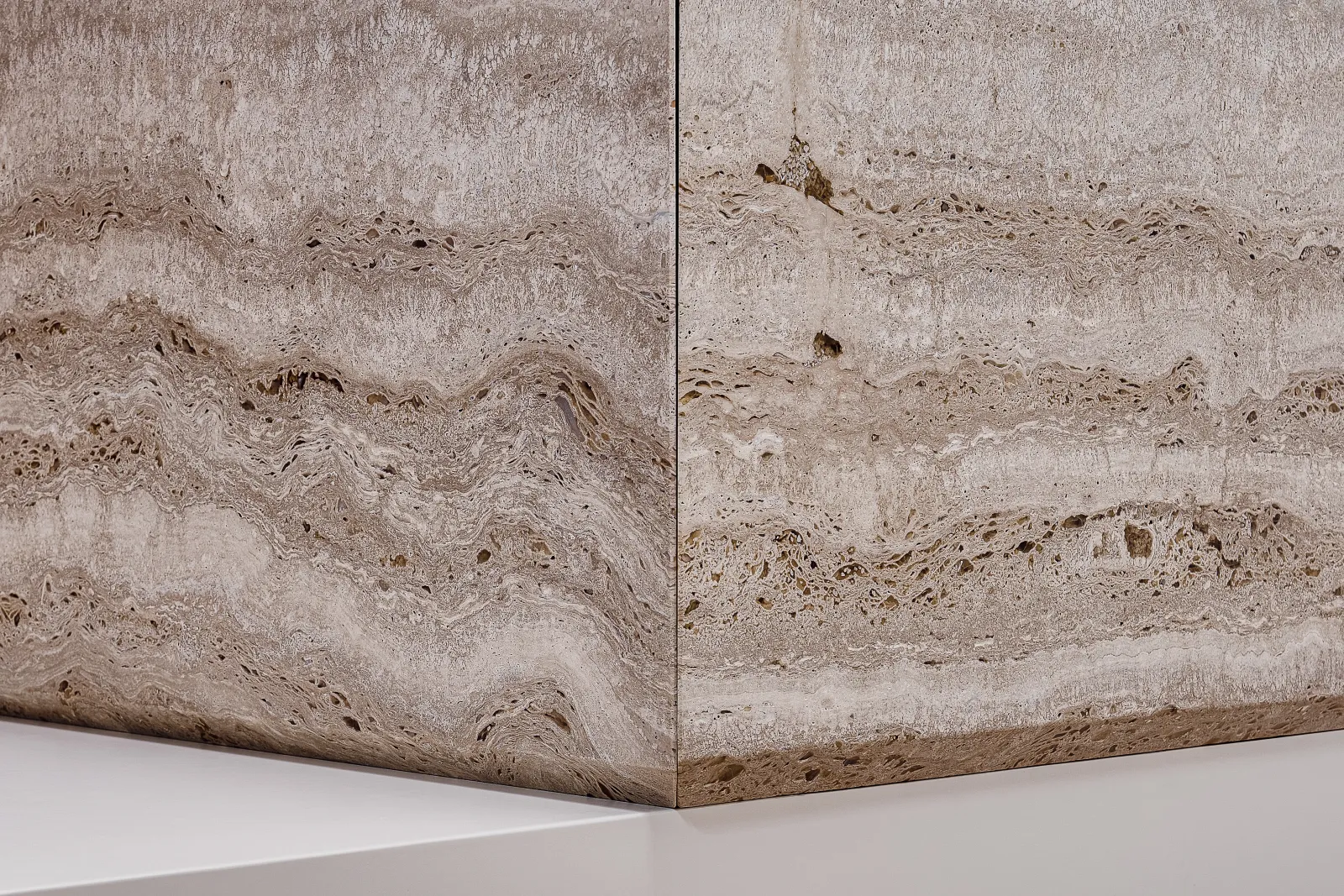La superficie di un blocco di travertino, con le sue venature e cavità naturali